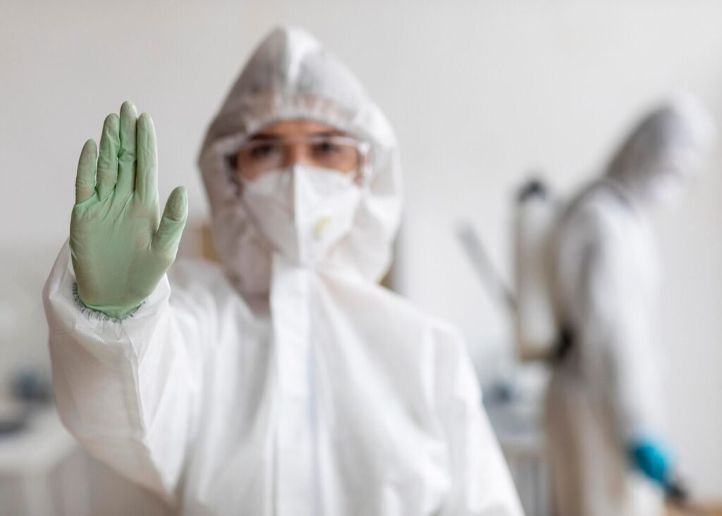people-wearing-protective-equipment-disinfecting-dangerous-area_23-2148848605